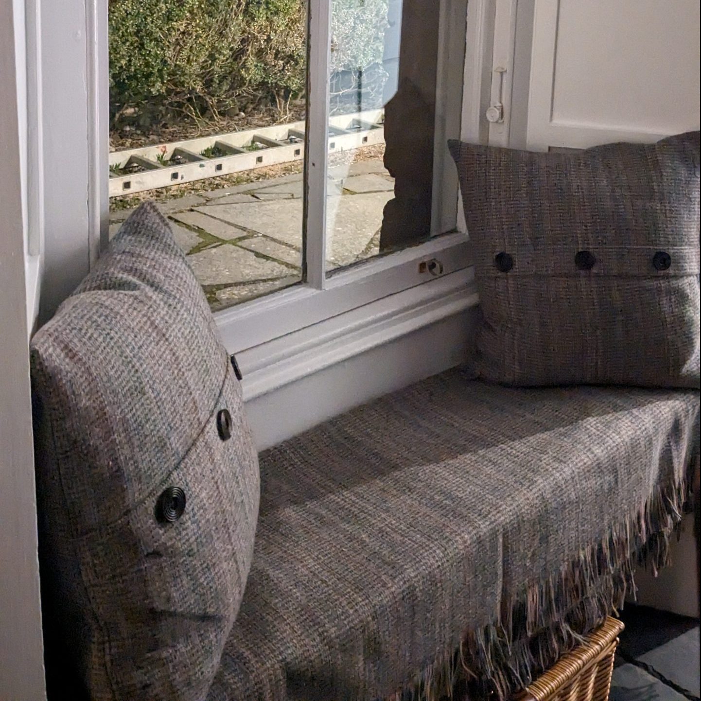 A vute little window seat with views out over the illuminated cathedral 